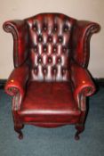 A 20TH CENTURY OXBLOOD LEATHER WINGBACK ARMCHAIR