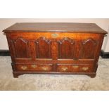 AN 18TH CENTURY OAK MULE CHEST, the hinged lid above a fielded four panel front, two drawers