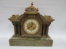 A GREEN VARIEGATED ONYX CASED MANTLE CLOCK OF ARCHITECTURAL FORM, having various gilded brass