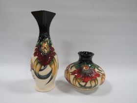 TWO MOORCROFT 'ANNA LILY' PATTERN VASES, comprising a slender vase with squared rim, H 21 cm, and