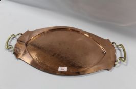 AN ART NOUVEAU OVAL COPPER TRAY, with twin handles, hammered finish, W 60.5 cm