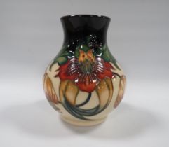 A MOORCROFT ANNA LILY PATTERN VASE, of bulbous form, with original price sticker to base covering