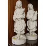 A PAIR OF VINTAGE PARIAN WARE STYLE FIGURINES OF YOUNG GIRLS HOLDING MR PUNCH PUPPETS
