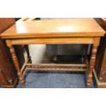 AN ANTIQUE FOLD-OVER CARD TABLE