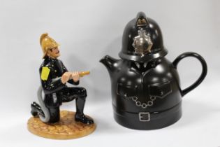 A ROYAL DOULTON FIGURE OF A FIREMAN - MARKED AS A SECOND, TOGETHER WITH A NOVELTY POLICEMAN