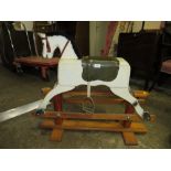 A SMALL TRESTLE ROCKING HORSE
