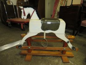 A SMALL TRESTLE ROCKING HORSE