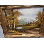 A GILT FRAMED OIL ON CANVAS OF MOUNTAIN RIVERSIDE SCENE