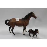 A BESWICK MODEL OF A SWISH TAIL HORSE IN MATT TOGETHER WITH A SMALL SHETLAND PONY (2)