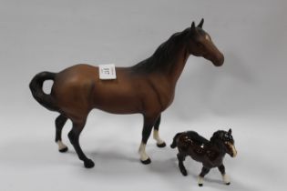 A BESWICK MODEL OF A SWISH TAIL HORSE IN MATT TOGETHER WITH A SMALL SHETLAND PONY (2)