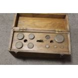 A WOODEN CASED SET OF SCALES AND WEIGHTS UNCHECKED