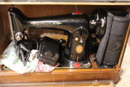 A VINTAGE CASED ELECTRIC SINGER SEWING MACHINE