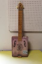 A CHILDS SIZE THREE STRINGS CIGAR BOX GUITAR