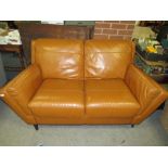 A MODERN TAN LEATHER TWO SEATER SETTEE - MINUS BACK FOOT