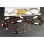 AN AMBER NECKLACE TOGETHER WITH A QUANTITY OF SILVER CHAINS ETC