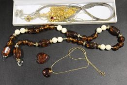 AN AMBER NECKLACE TOGETHER WITH A QUANTITY OF SILVER CHAINS ETC