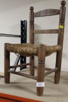 A SMALL REED SEATED OAK TEDDY BEAR CHAIR