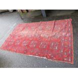 A VINTAGE RED WOOLLEN RUG 254 X 154 cm