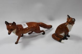 A BESWICK RUNNING FOX TOGETHER WITH A MODERN SEATED EXAMPLE (2)