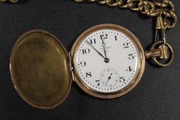 A GOLD PLATED WALTHAM FOUR HUNTER POCKET WATCH ON A GOLD EFFECT CHAIN