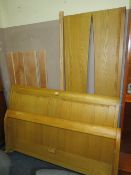 A MODERN LIGHT OAK SLEIGH BED FRAME WITH FITTINGS - W 162 cm