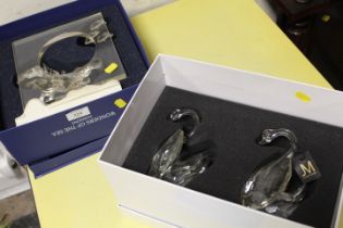 A BOXED SWAROVSKI CRYSTAL WONDERS OF THE SEA "HARMONY" DISPLAY TOGETHER WITH TWO CRYSTAL SWANS