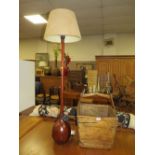 A LARGE WOODEN CARRY BASKET - H 58 cm, W 40 cm TOGETHER WITH A STANDARD LAMP (2)