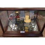 A MODEL OF AN ANTIQUE STEAM POWERED MOTOR CAR IN A GLASS AND MAHOGANY DISPLAY CASE
