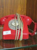 A RED DIAL TELEPHONE WITH CONNECTOR FOR THE MODERN NETWORK
