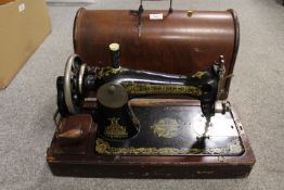 A CASED SINGER SEWING MACHINE MODEL NUMBER F8988263