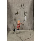 A VINTAGE CLOCKWORK 'CHILD ON A SWING', with metal frame, overall H 44 cm