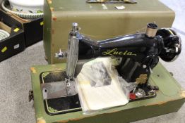 A VINTAGE CASED LUCIA SEWING MACHINE