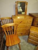 A HONEY PINE FOUR DRAWER CHEST TOGETHER WITH A BEDSIDE CHEST, TWO CHAIRS AND A MIRROR