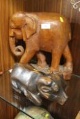 A CARVED WOODED ELEPHANT TOGETHER WITH A RECUMBENT RAM (2)