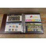 AN ALBUM CONTAINING VARIOUS STAMP COLLECTORS SETS