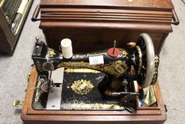 AN ANTIQUE MAHOGANY CASED SINGER SEWING MACHINE MODEL J770337
