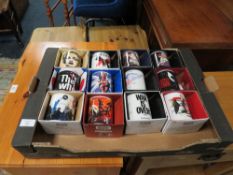 A TRAY CONTAINING 12 NEW BOXED POP MUSIC RELATED MUGS TO INCLUDE THE WHO x 2, MADONNA, KINGS OF LEON