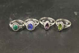 A COLLECTION OF FOUR 925 SILVER GEMSTONE DRESS RINGS TO INC AMETHYST, PERIDOT ETC