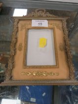 A GILT METAL ORNATE MINIATURE PICTURE FRAME