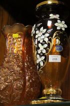 A BOHEMIAN GLASS DECORATIVE VASE ( CHIP TO RIM ) TOGETHER WITH A CARNIVAL GLASS VASE (2)