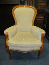 A REPRODUCTION UPHOLSTERED GENTLEMANS ARMCHAIR