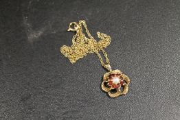 A HALLMARKED 9 CARAT GOLD RUBY AND SEED PEARL PEDANT 2.4G APPROX