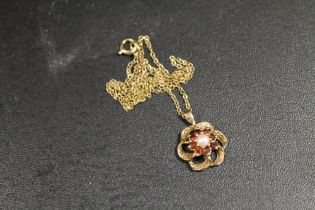 A HALLMARKED 9 CARAT GOLD RUBY AND SEED PEARL PEDANT 2.4G APPROX