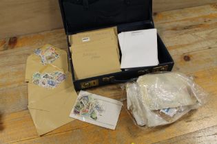A COLLECTION OF ASSORTED STAMPS ETC CONTAINED IN A SMALL BRIEFCASE