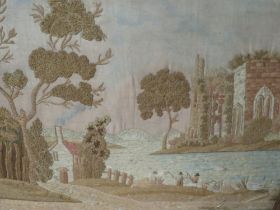 AN ANTIQUE WOOLWORK WOODED RIVER SCENE WITH ANGLERS AND ABBEY RUINS