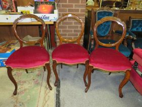 A SET OF THREE MAHOGANY CARVED DINING CHAIRS