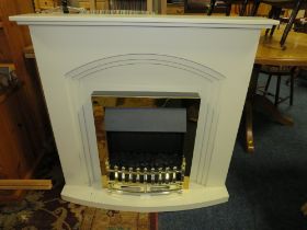 A MODERN ELECTRIC FIRE IN A CREAM SURROUND