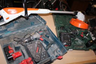 A RECHARGEABLE STIHL STRIMMER TOGETHER WITH TWO CORDLESS BOSCH DRILLS