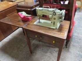 A TABLE CASED SINGER ELECTRIC SEWING MACHINE