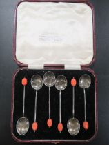 A CASED SET OF HALLMARKED SILVER COFFEE BEAN SPOONS WITH PINK FINIALS